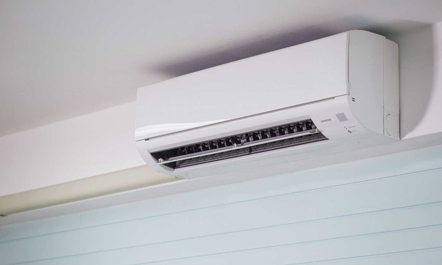 Wall-mounted ductless mini split indoor unit in a bright room