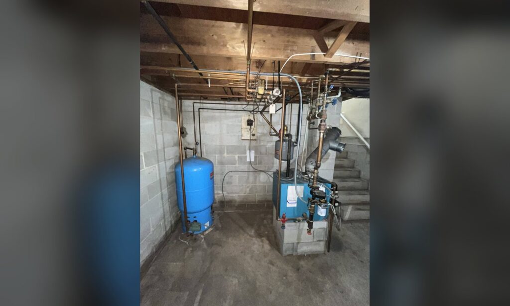 Basement boiler and expansion tank installed by Unity Heating & Air Conditioning