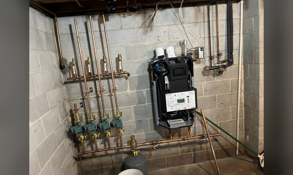 Gas boiler and copper zone valve manifold installed by Unity Heating & Air Conditioning