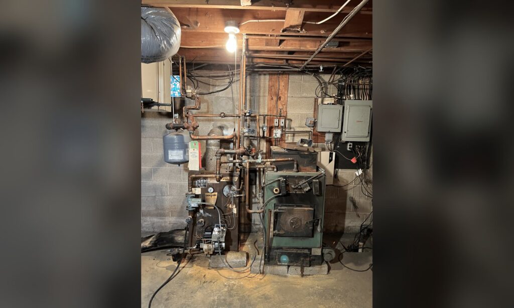 Older oil boiler in a Lehigh Valley basement before replacement by Unity Heating & Air Conditioning