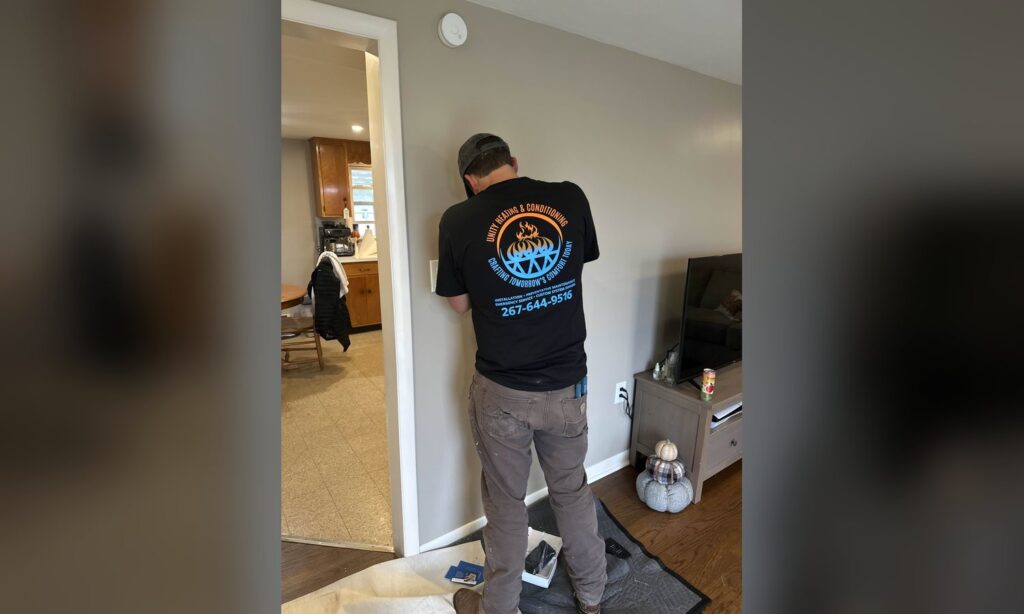 Unity Heating & Air Conditioning technician on a service call in a Lehigh Valley home