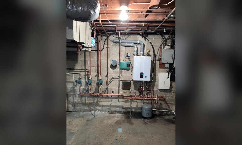 Wall-hung condensing boiler with zone pumps and new copper piping installed by Unity Heating & Air Conditioning